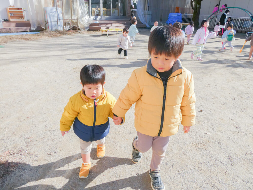 手をつなぐ園児2人